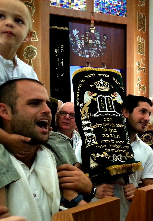 Holding one of 11 sacred Torah scrolls in a Tel Aviv synagogue this morning on Simchat Torah. 11 Sacred Torah scrolls-Simchat-Torah-Israel-synagogue