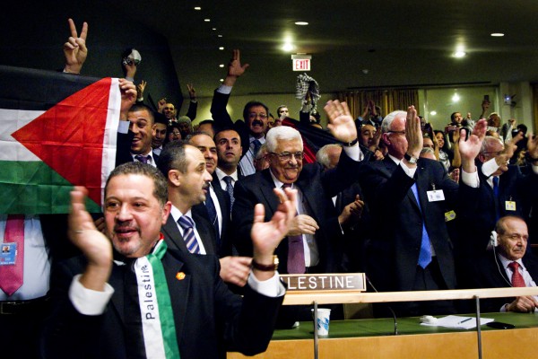 Palestinian Authority President Mahmoud Abbas and his delegation celebrate after the Assembly's decision Abbas-celebrate-UN vote
