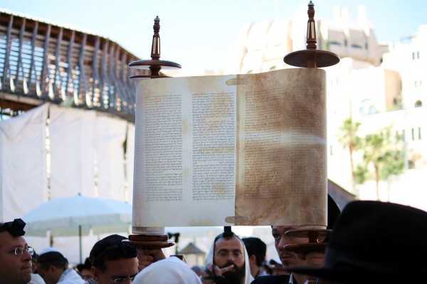 The Magbiah ("lifter") has the honor of Hagbahah (lifting) and displaying the Torah's Hebrew text for all to see Sefer-Torah-Hagbah
