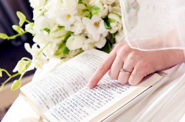 A Jewish bride reads the Siddur (Jewish prayer book) wedding-ring-bride
