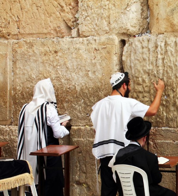 Jewish men cover their heads as they pray at the Western Wall Jewish men-kippah-tallit-prayer shawl-traditional hat-ultra-Orthodox
