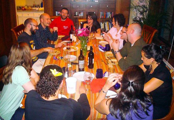 Family and friends catching up over a Shabbat dinner family-friends-talk-Shabbat-dinner