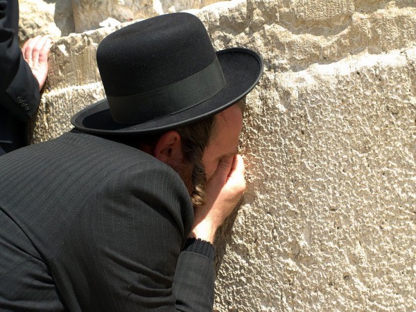 An Orthodox Jewish man prays earnestly at the Western Wall An Orthodox Jewish man prays earnestly at the Western Wall