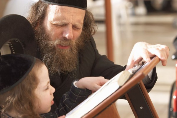 An Orthodox Jewish father teaches his son to follow the Siddur father-son-Siddur-Western (Wailing) Wall-Jerusalem