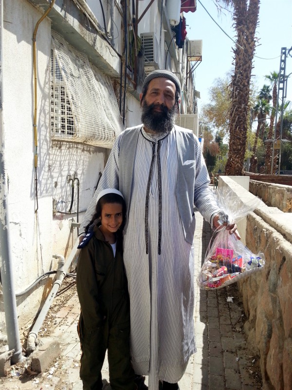 An Israeli father and son are on their way to deliver a mishloach manot father-son-Mishloach-manot-Purim