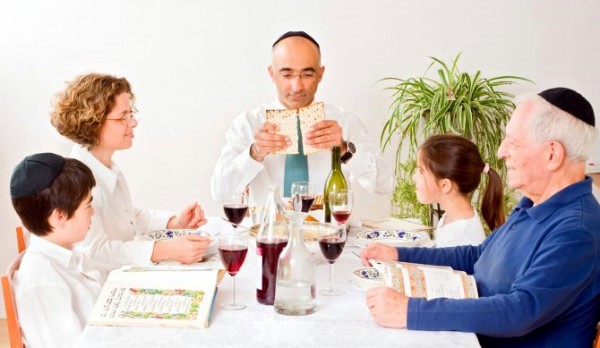 A Jewish family breaks matzah Jewish family-Matzah-Passover-Pesach-Seder