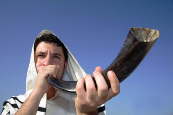 Sounding a shofar shofar-blower