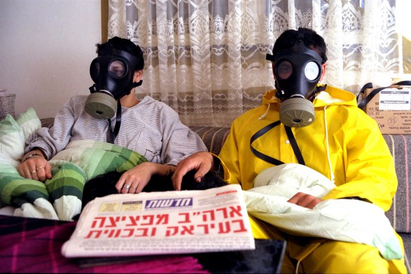 Israeli family sits inside its sealed room bomb shelter-gas masks-Israel