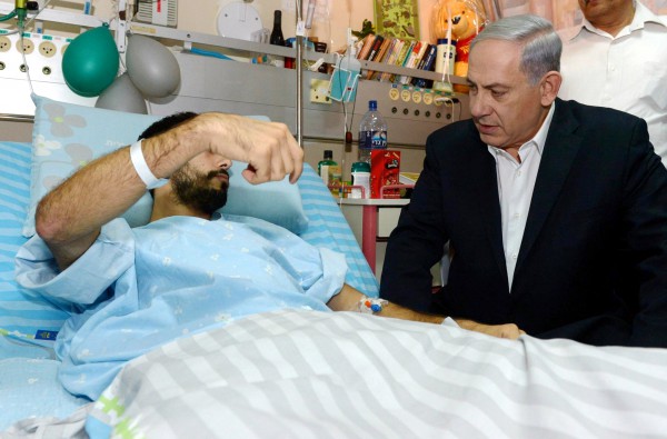 Prime Minister Benjamin Netanyahu visits an Israeli soldier who was wounded during Operation Protective Edge. Prime Minister Benjamin Netanyahu visits an Israeli soldier who was wounded during Operation Protective Edge.
