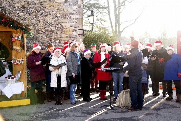 Members of the Winchester Musicals and Opera Society sing carols at Winchester Cathedral in England. Members of the Winchester Musicals and Opera Society sing carols at Winchester Cathedral in England.
