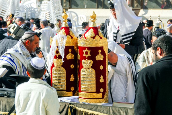 A 13-year-old Jewish boy stands before the Torah scroll during his Bar Mitzvah at the Western (Wailing) Wall in Jerusalem. A 13-year-old Jewish boy stands before the Torah scroll during his Bar Mitzvah at the Western (Wailing) Wall in Jerusalem.