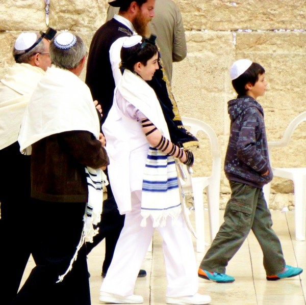 A 13-year-old Jewish boy carries the Torah scroll publicly for the first time at the Western (Wailing) Wall in Jerusalem. A 13-year-old Jewish boy carries the Torah scroll publicly for the first time at the Western (Wailing) Wall in Jerusalem.