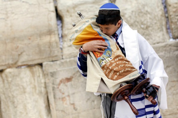 A 13-year-old Jewish boy pays respect to the Torah. (Ministry of Tourism photo taken by Yonatan Sindel, Flash 90) A 13-year-old Jewish boy pays respect to the Torah. (Ministry of Tourism photo taken by Yonatan Sindel, Flash 90)