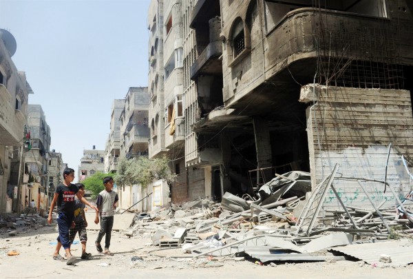 Three Palestinian youth inspect the remains of a house in the Sheikh Radwan northwest of Gaza City Three Palestinian youth inspect the remains of a house after it was hit in Israeli air strike in the Sheikh Radwan district against Muhammed Deif, the head of Hamas' military wing. (UN photo by Shareef Sarhan)