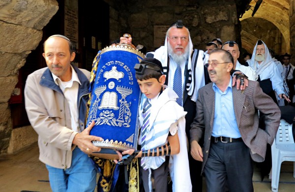 Bar-Mitzvah Jewish father and son, Western (Wailing) Wall, Jerusalem, carrying Torah scroll