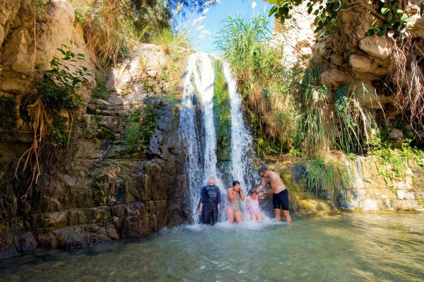A father and his children refresh themselves at the Ein Gedi oasis, which is near Masada and the Dead Sea. A father and his children refresh themselves at the Ein Gedi oasis, which is near Masada and the Dead Sea.