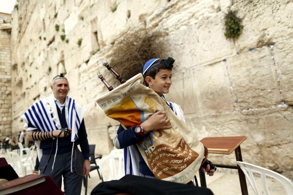 A 13-year-old Jewish boy carries the Torah scroll at the Western (Wailing) Wall. (Israel Ministry of Tourism photo by Jonathan Sindel) A 13-year-old Jewish boy carries the Torah scroll at the Western (Wailing) Wall. (Israel Ministry of Tourism photo by Jonathan Sindel)
