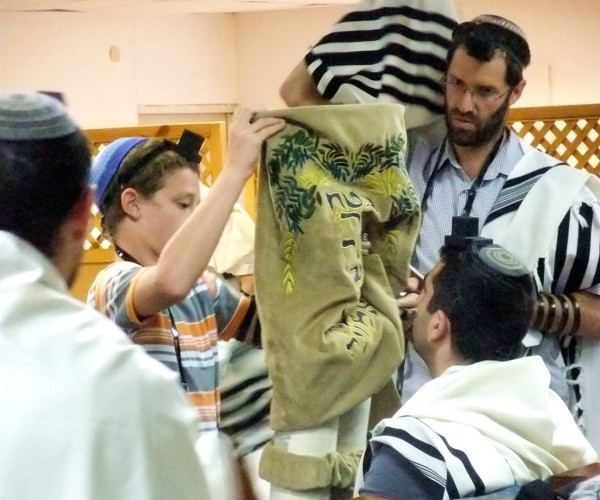 If the Torah scroll is not housed in a Torah tik (case), after the Torah reading, the Golel (roller) performs Gelila (rolling up). The Torah is then bound with a sash and covered with the Torah cover. The honor of being the Golel is sometimes given to a child under Bar Mitzvah age. If the Torah scroll is not housed in a Torah tik (case), after the Torah reading, the Golel (roller) performs Gelila (rolling up). The Torah is then bound with a sash and covered with the Torah cover. The honor of being the Golel is sometimes given to a child under Bar Mitzvah age.