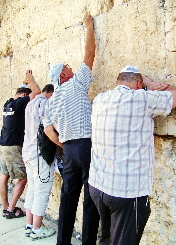Jewish men pray at the Western (Wailing) Wall in Jerusalem, where it is traditional to stuff prayers on slips of papers in the crevices of the wall. Jewish men pray at the Western (Wailing) Wall in Jerusalem, where it is traditional to stuff prayers on slips of papers in the crevices of the wall.