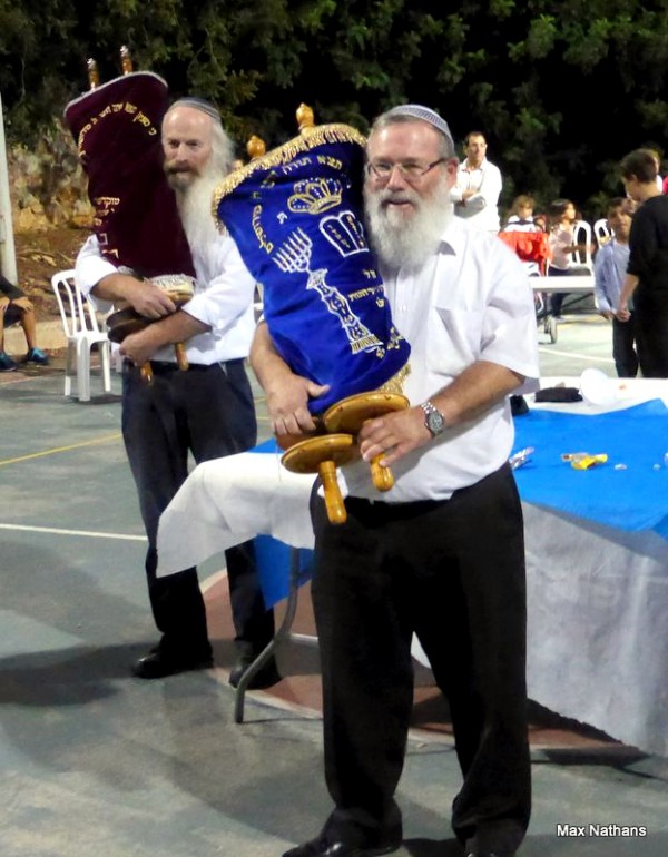 It is considered a mitzvah (good deed) to dance with the Torah and to rejoice over it on Simchat Torah. (Photo by Max@Nathans) It is considered a mitzvah (good deed) to dance with the Torah and to rejoice over it on Simchat Torah. (Photo by Max@Nathans)