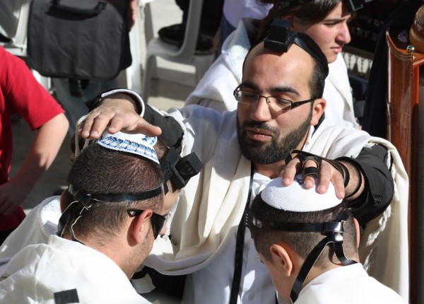 A blessing is recited over two Jewish youth at the Western Wall, also known as the Wailing Wall and the Kotel. (Photo by Kyle Taylor) A blessing is recited over two Jewish youth at the Western Wall, also known as the Wailing Wall and the Kotel. (Photo by Kyle Taylor)