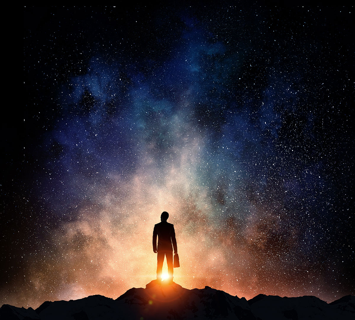 silhouette of man looking up into space